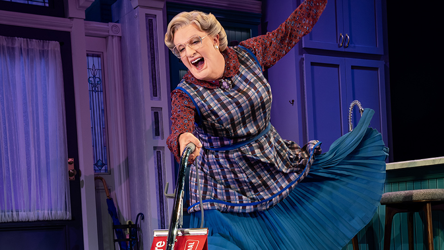 Rob McClure pushes a vacuum on stage as Mrs. Doubtfire