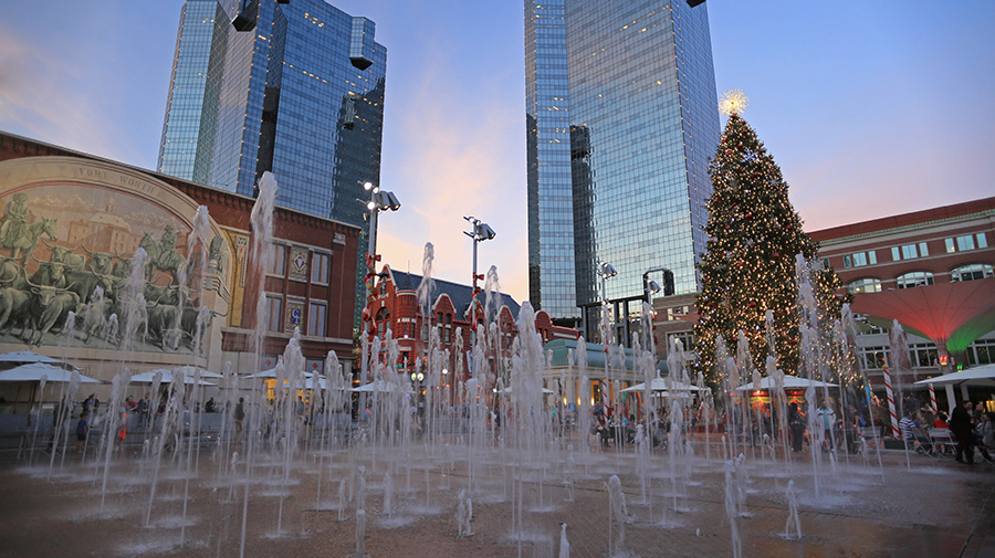 Fountains at Sundance Square in Fort Worth dance in front of the lighted downtown Christmas tree