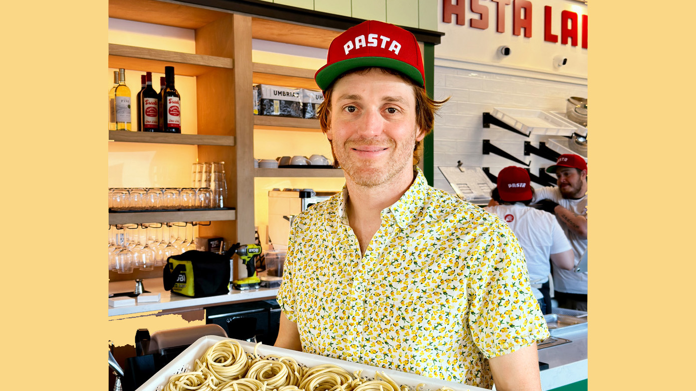 Davide Mocchi holds a platter of delicious cuisine