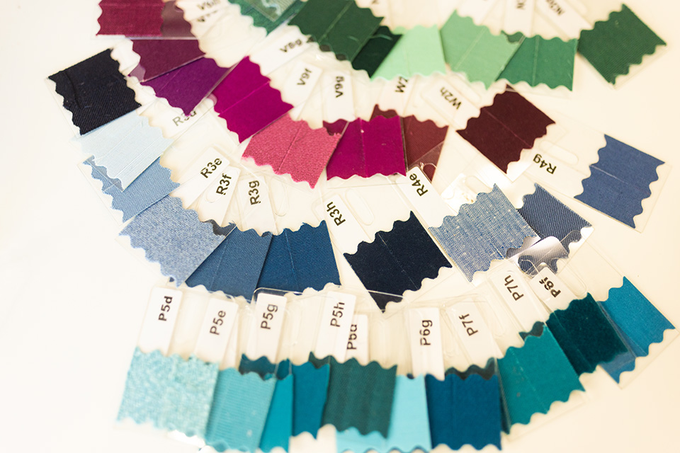 A close-up of blue, green and deep pink color swatches