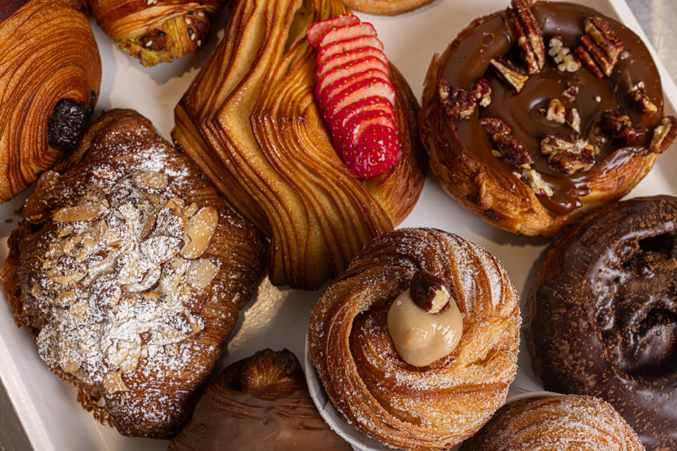 A variety of treats from D'Caramel Patisserie feature strawberries, chocolate, and nuts.