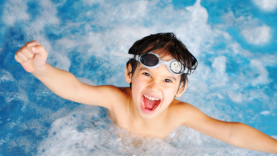 A happy boy swimming