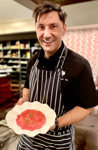 Chef Peja Krstic holds a plate of tuna with crabmeat