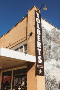 The exterior sign of Tolbert's has a distinctly Western feel.