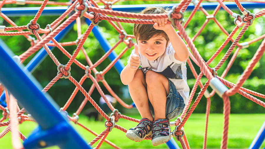 A young boy plays on a playground