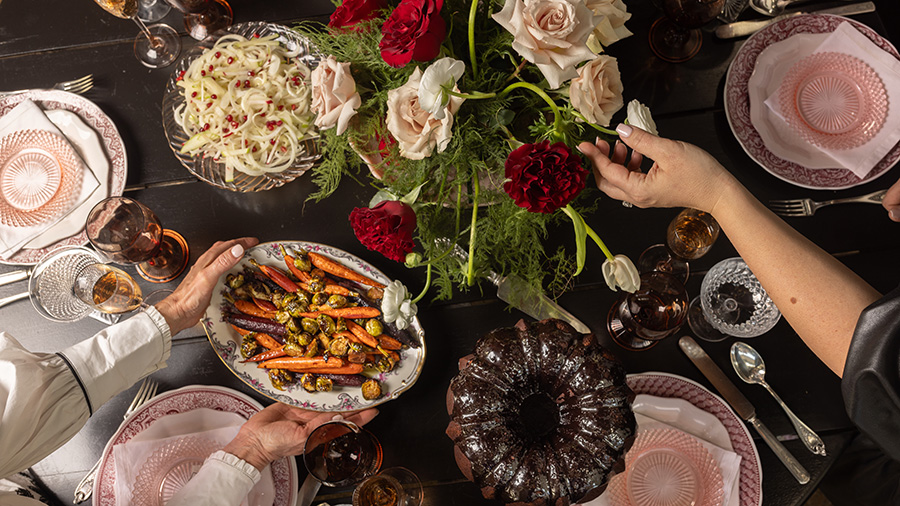 A beautiful tablescape by Bodega, with flowers, dishes and food.