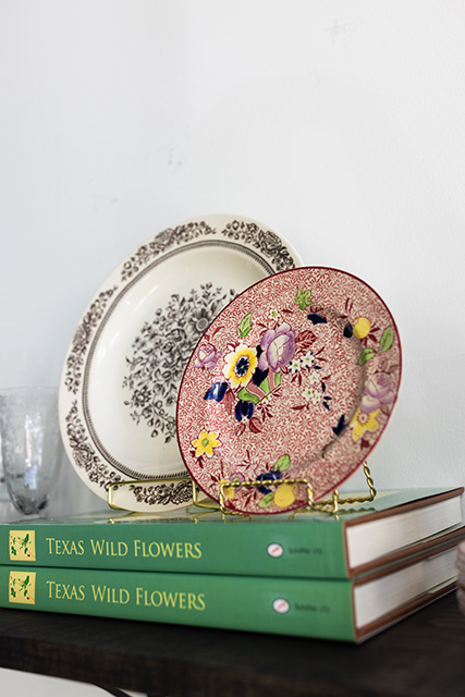 Two vintage dishes sit atop two books.