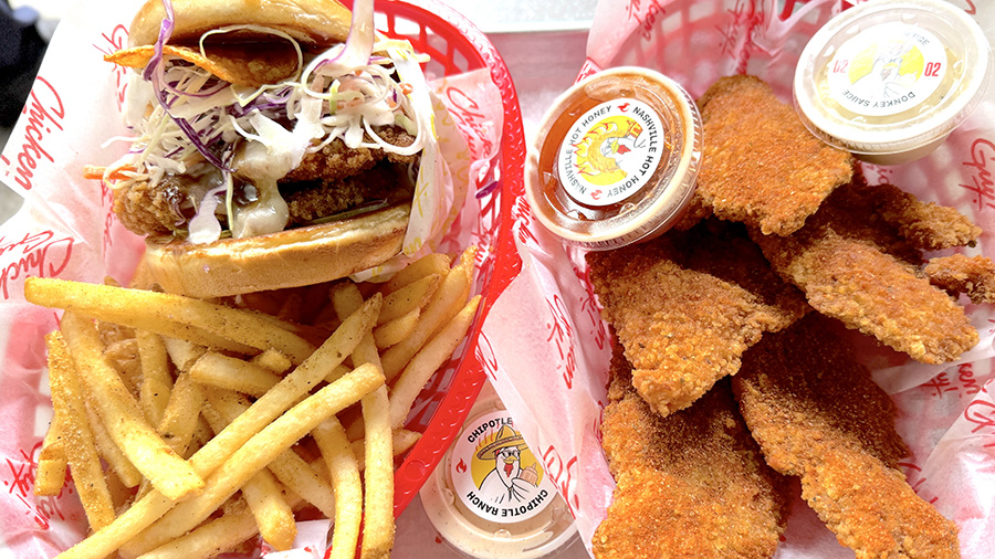 A chicken sandwich with fries, and chicken strips at Chicken Guy!