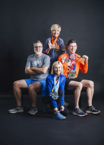 Betsy Price, Patrick Newman, Macy Hill and Troy Langston show their marathon medals