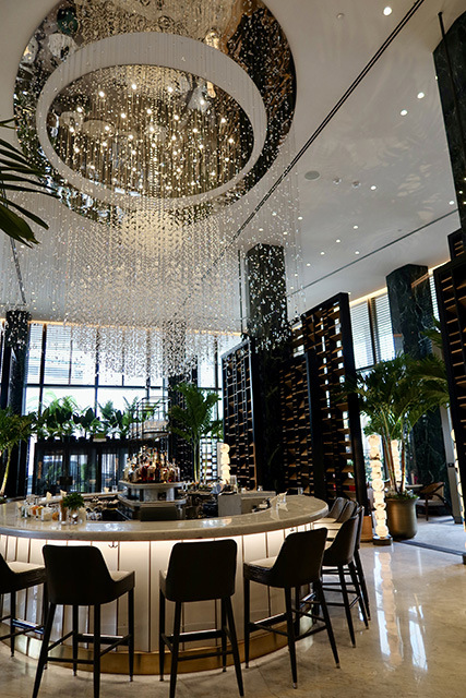 A beautiful chandelier hangs from the ceiling at The Chandelier Bar