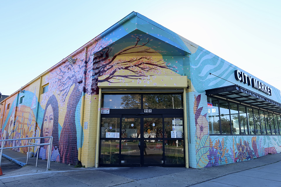 The exterior of City Market is covered in beautiful murals