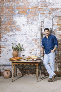 Alessandro Salvatore stands by a table at Bocca Osteria Romana