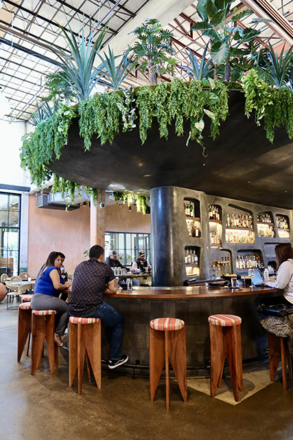 Guests sit around the outdoor bar at Mezquite.