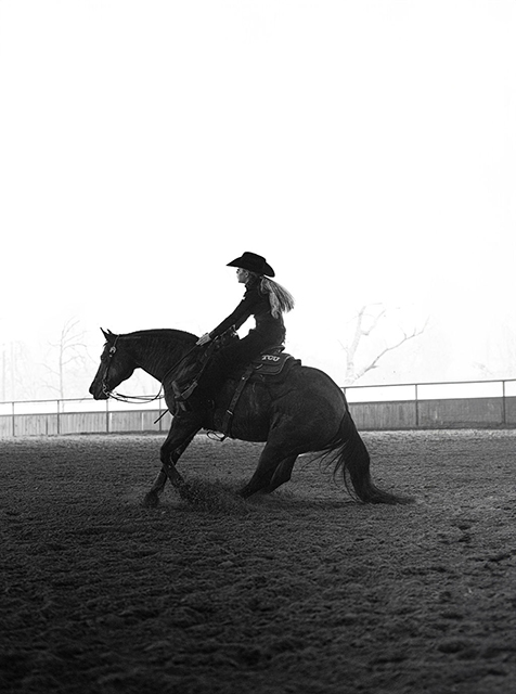 One TCU equestrian's student-athletes rides a horse in an arena.