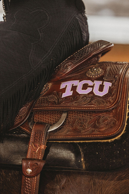 The back of a saddle displays "TCU" in purple lettering.