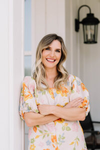 Taylor Dukes stands against a doorway, happy and healthy