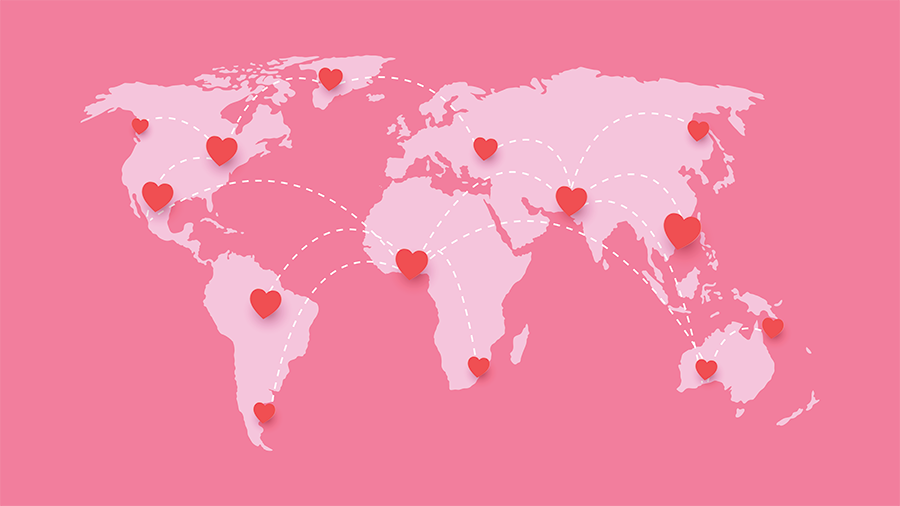 A pink graphic of a world map, showing hearts all across the world