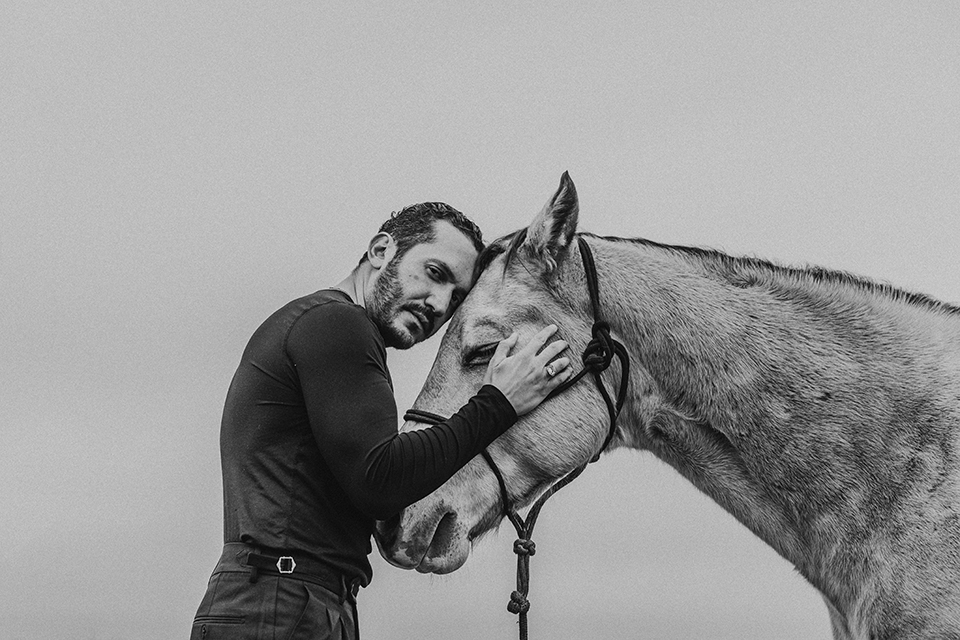 Photographer Emerson Miller poses with a horse