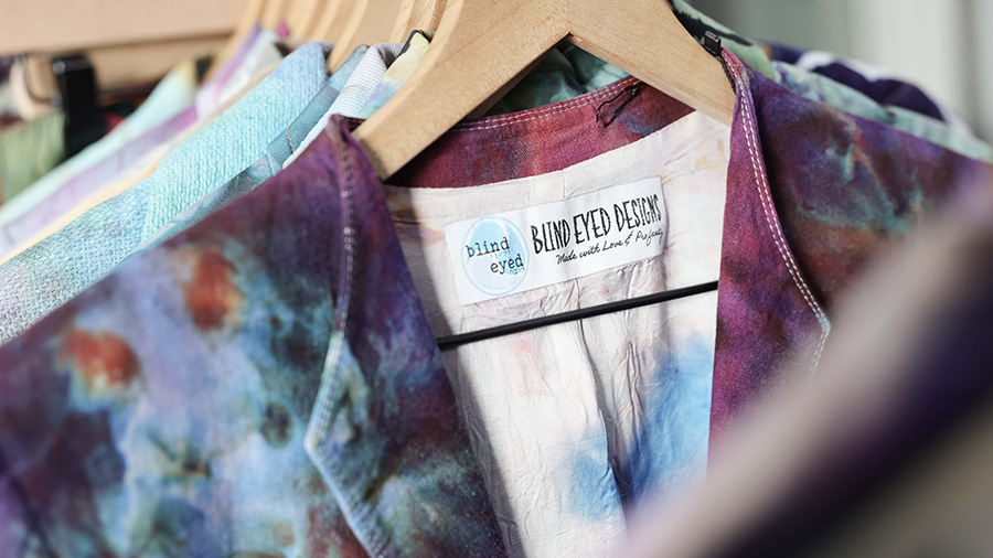 Ice-dyed clothing on hangers